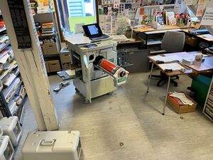EZ570e with open front door and a red drum, paper in the tray and a lot of printed matters and other stuff everywhere